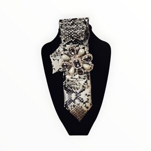 Elegant Black and White Snake Print Tie with Jewel Brooch